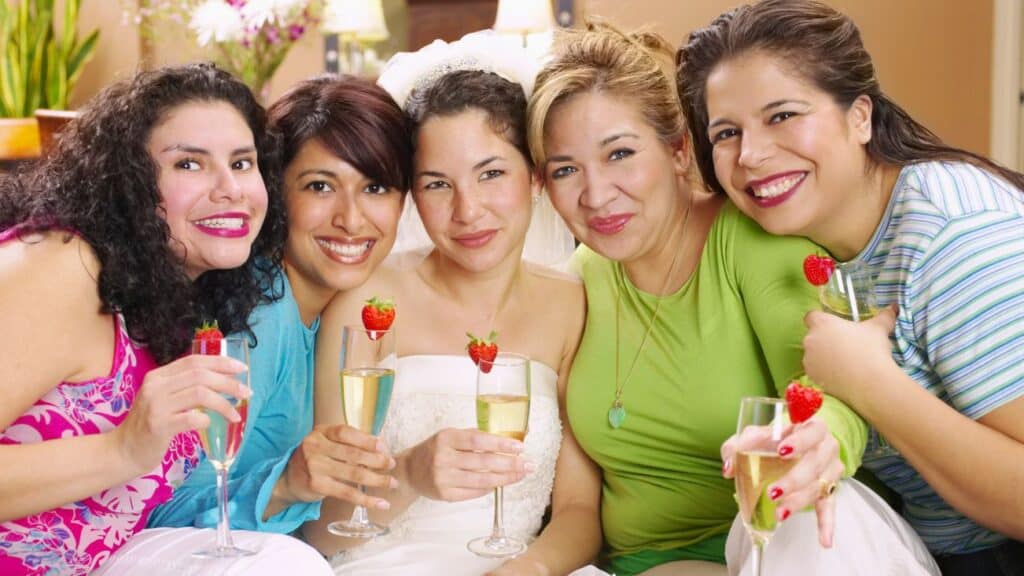 ladies gathered around bride with champagne
